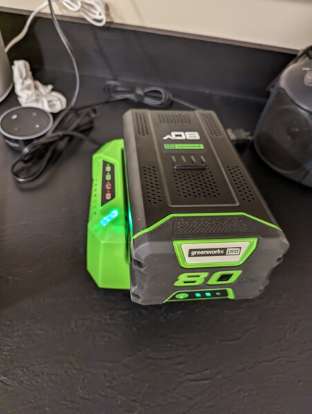 greenwork pro 80v battery inside a charger
